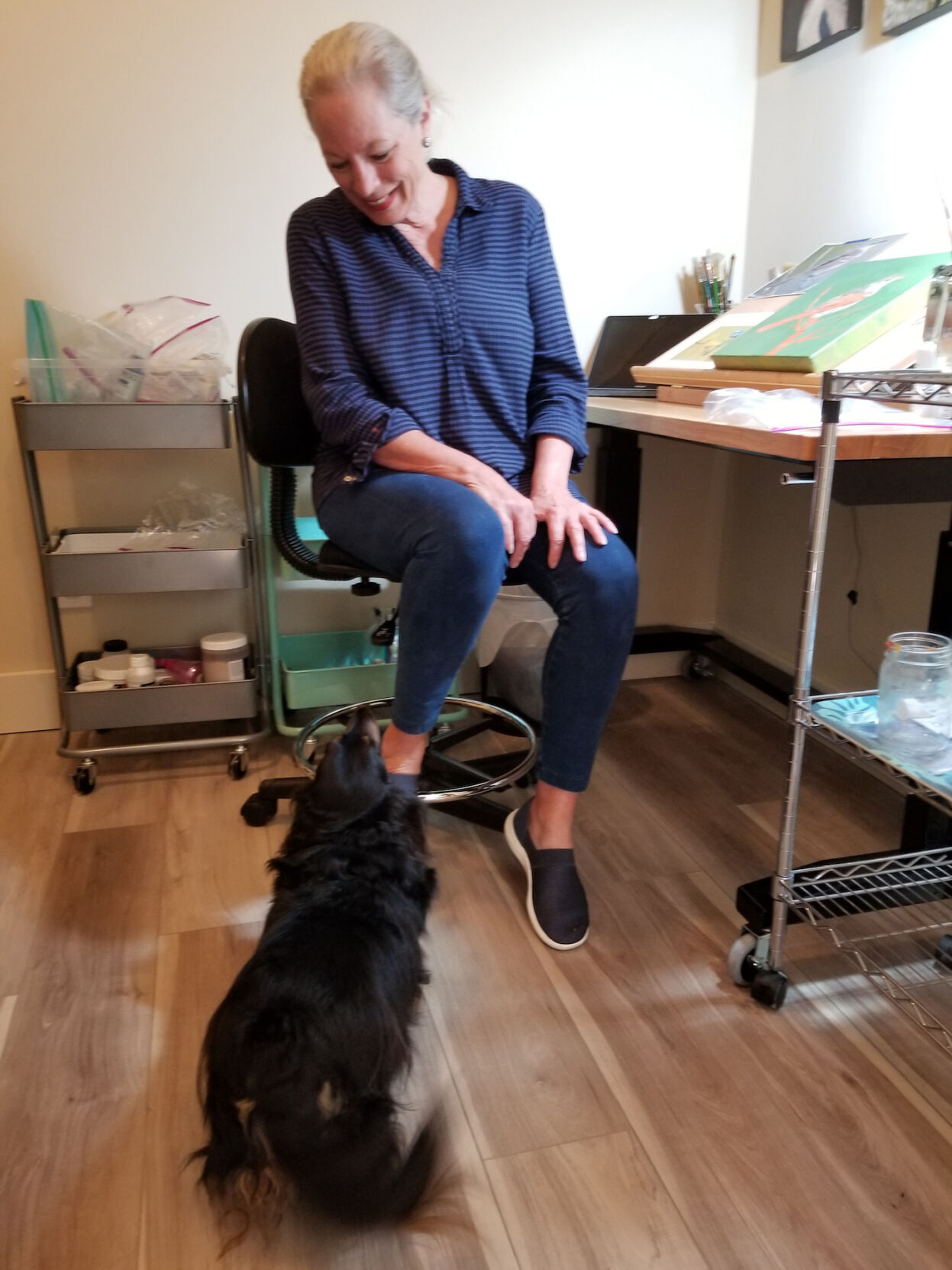 Barbara Jensen takes a break in her studio with her dachshund, Dewey.